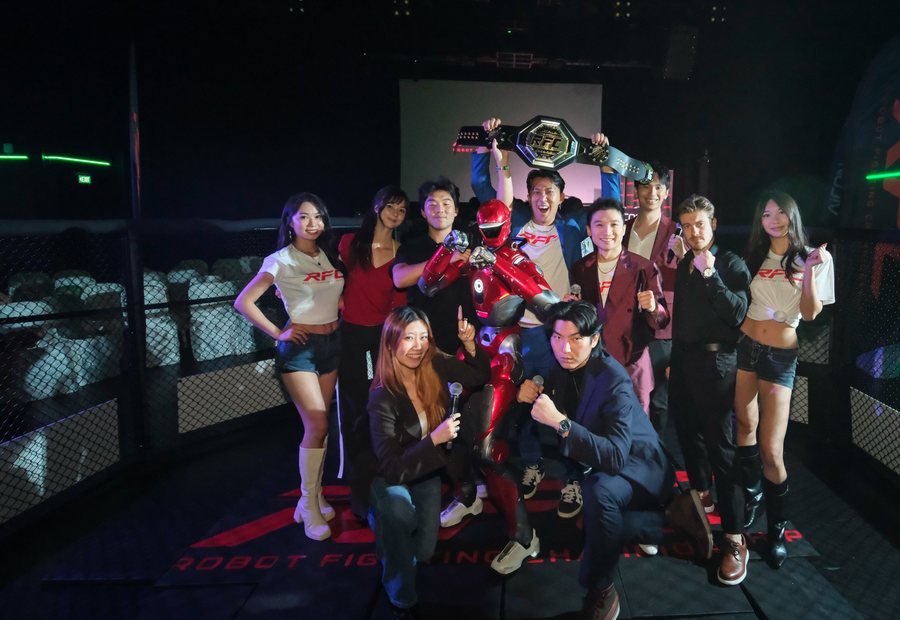 The RFC team and crew in the cage holding the championship belt
